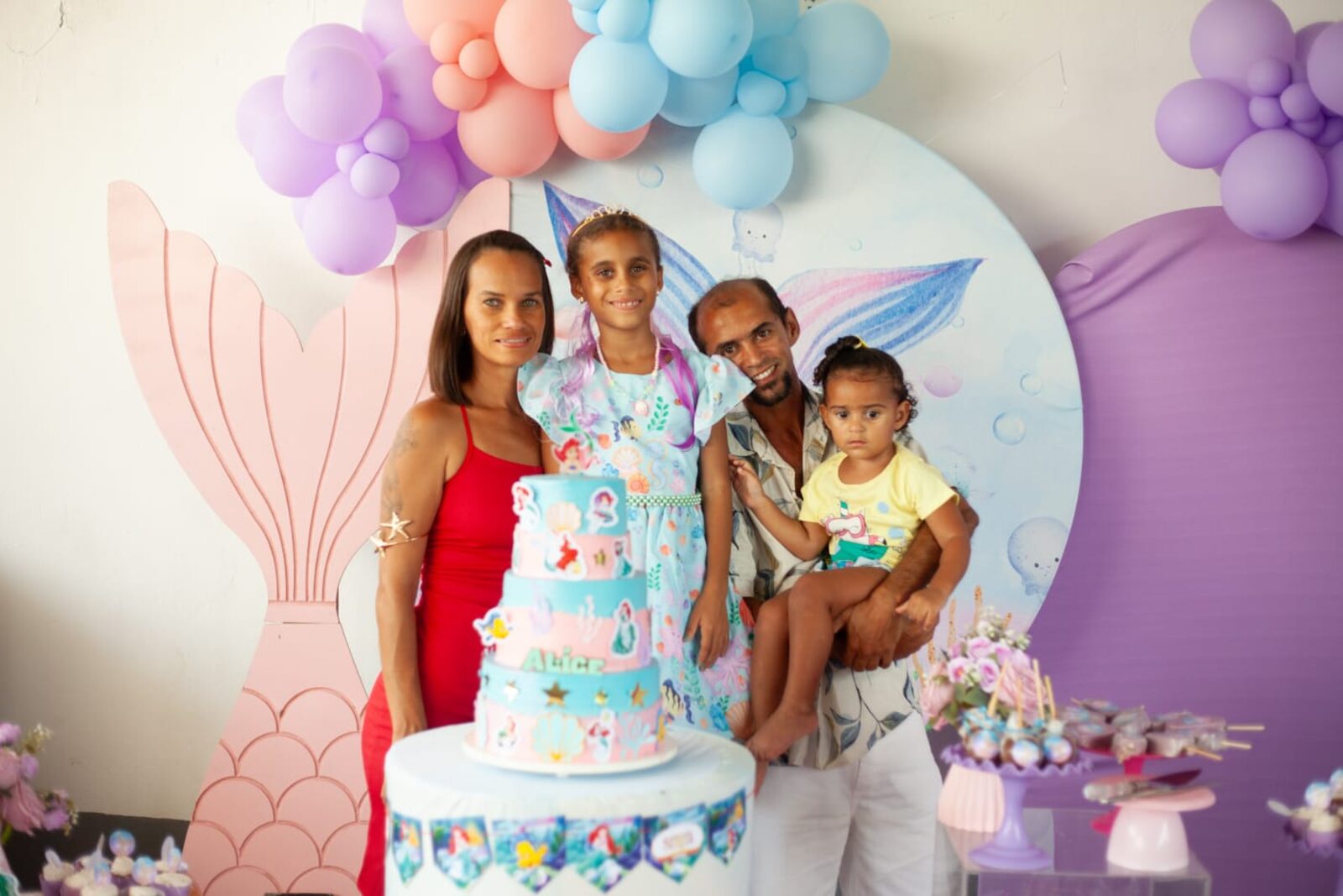 Família reunida ao redor do bolo de aniversário