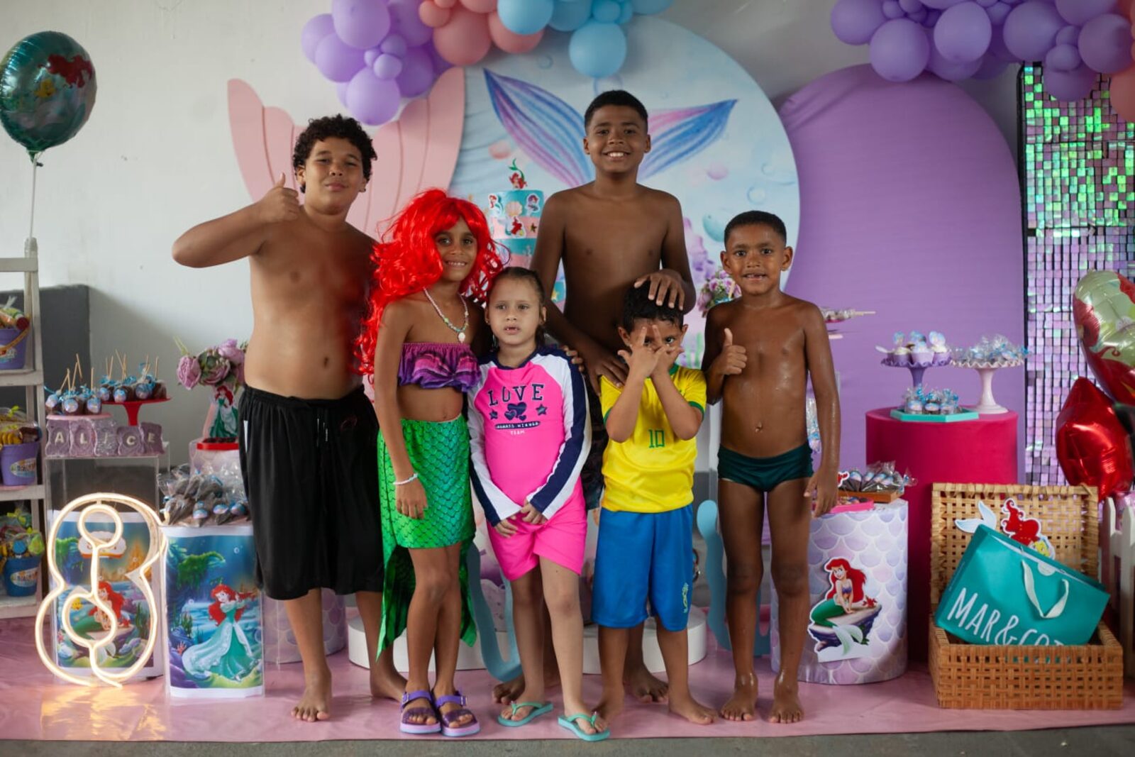 Grupo de crianças reunidas no cenário decorado da festa